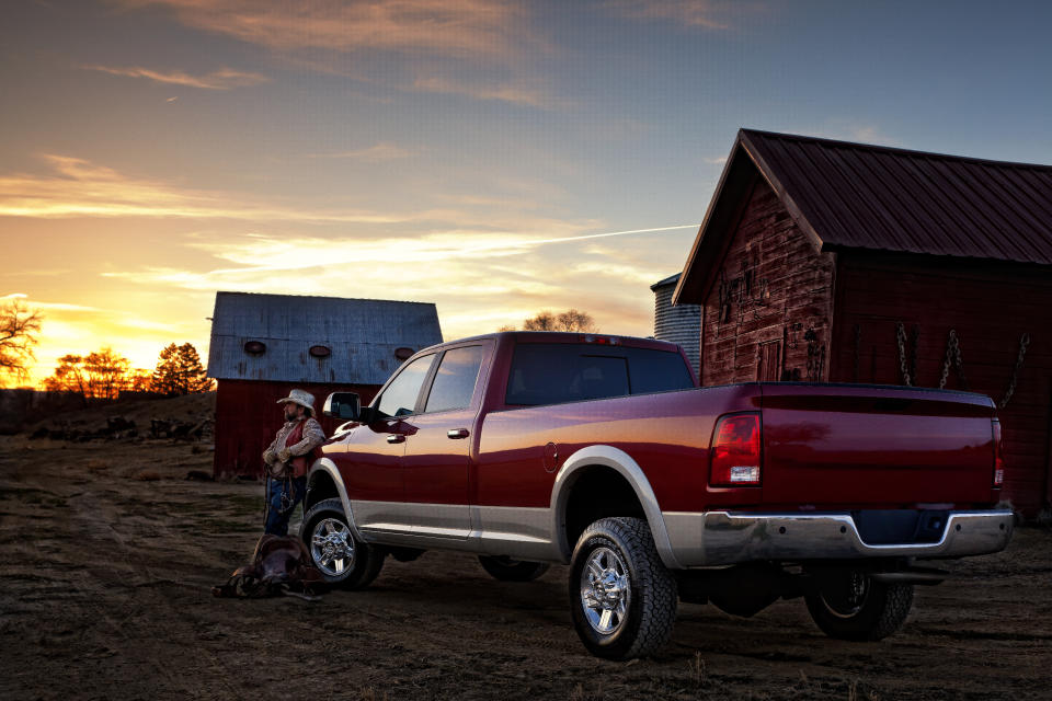 a man standing next to an expensive truck