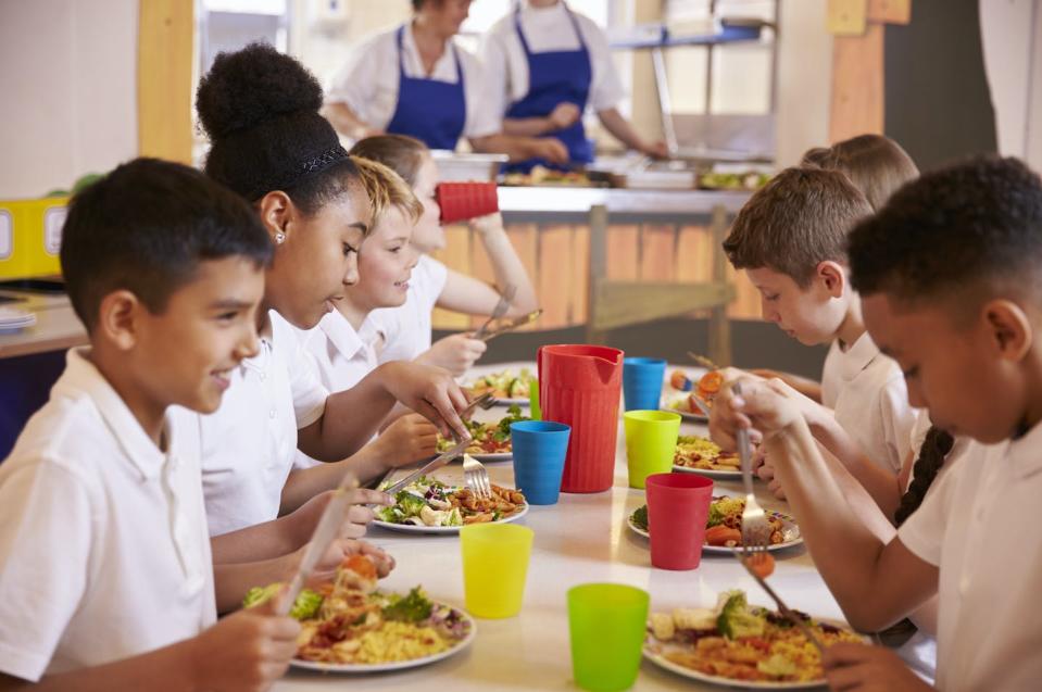 Eating together provides an opportunity for students to develop their social skills. Shutterstock