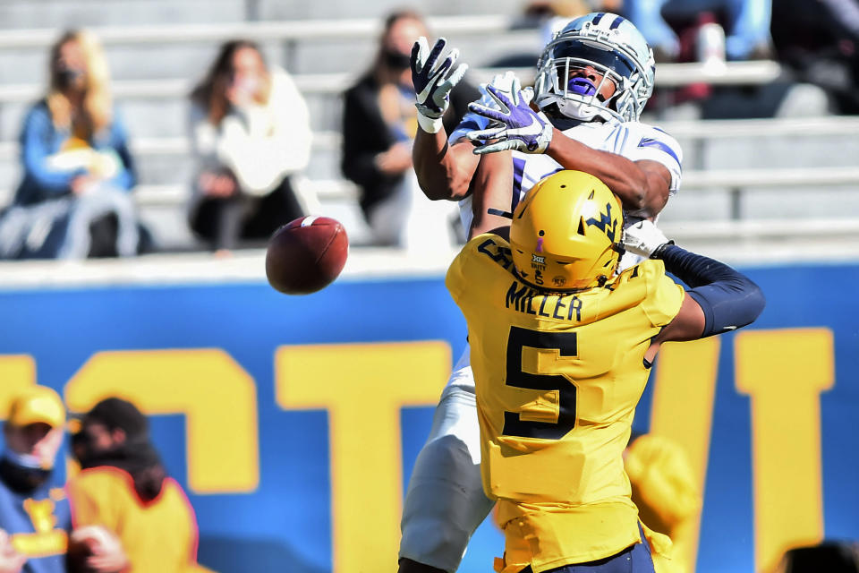 West Virginia cornerback Dreshun Miller (5) breaks up the pass intended for Kansas State wide receiver Chabastin Taylor (13) during an NCAA college football game Saturday, Oct. 31, 2020, in Morgantown, W.Va. (William Wotring/The Dominion-Post via AP)