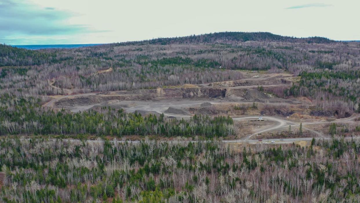 Two Quebec-based companies hope to turn this existing quarry into a large mine near Dalhousie in northern New Brunswick. The area is home to a vast deposit of pozzolan, a volcanic rock that can be used by the cement industry to lower emissions. (Michael Heenan/CBC - image credit)