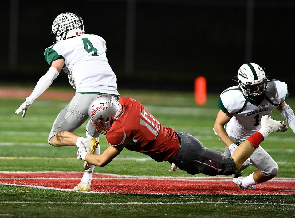 Jason Greenfield of Northwest makes a tackle on Mentor Lake Catholic quarterback Joe Malchesky in the third quarter.