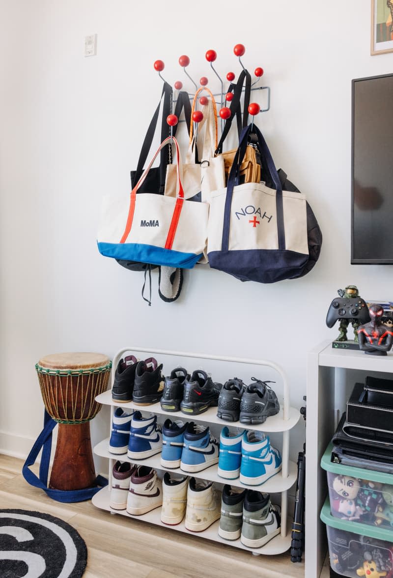 Entryway with shoe rack and colorful wall hooks