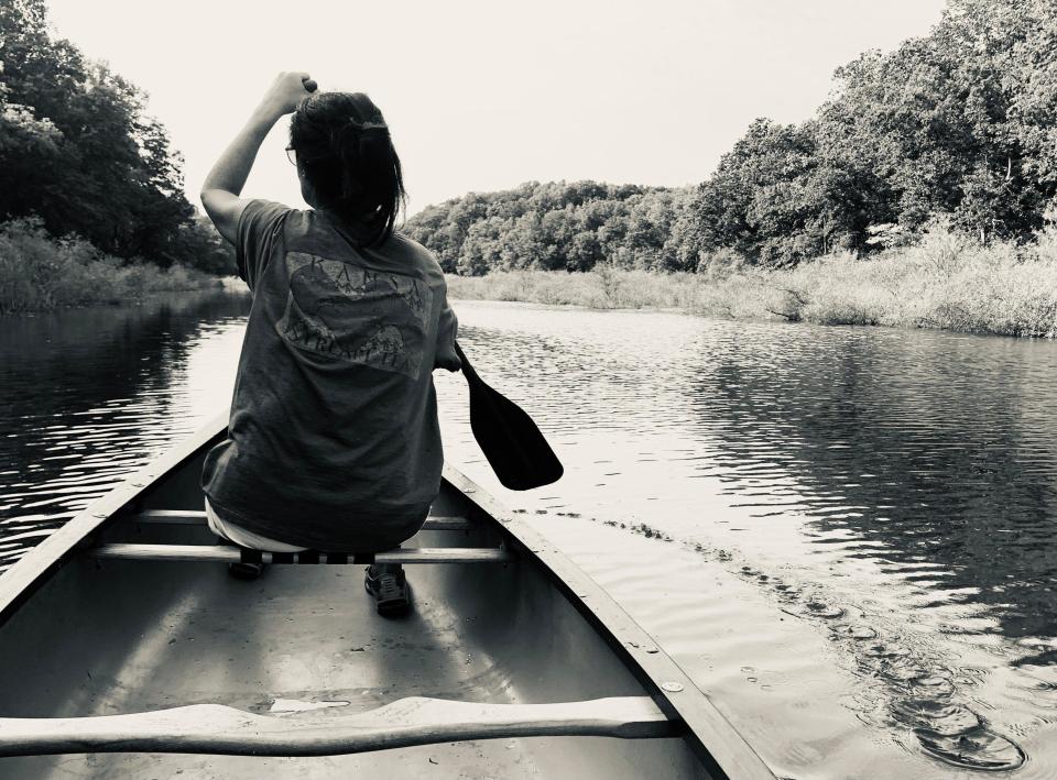 A person paddling in a canoe