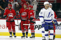 The Caroline Hurricanes celebrate a goal by Jesperi Kotkaniemi (82), during the first period of an NHL pre season hockey game against the Tampa Bay Lightning in Raleigh, N.C., Tuesday, Sept. 28, 2021. (AP Photo/Karl B DeBlaker)
