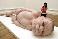 A visitor to the National Galleries of Scotland views the work of Australian born, London-based sculptor Ron Mueck on August 4, 2006 Edinburgh in Scotland. Meuck's sculptures explore the full life cycle, encompassing birth, adolescence, procreation middle age, old age, and death. (Photo by Jeff J Mitchell/Getty Images)