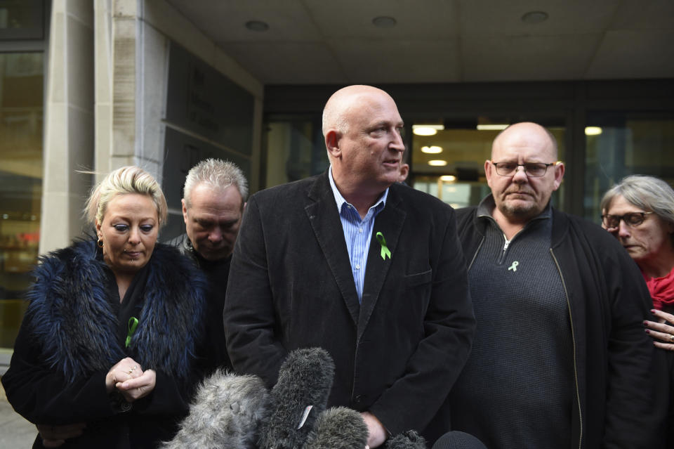 The family of Harry Dunn, from left, mother Charlotte Charles, stepfather Bruce Charles, family spokesman Radd Seiger, father Tim Dunn and stepmother Tracey Dunn speak to the media outside the Ministry Of Justice in London, Friday, Dec. 20, 2019. British prosecutors have charged the wife of an American diplomat over the death of a teenage motorcyclist in a road accident. British police say Harry Dunn died when he was hit by a car driven by Anne Sacoolas, whose husband was stationed at a U.S. military base in England. Sacoolas claimed diplomatic immunity and left Britain after the crash. (David Mirzoeff/PA via AP)