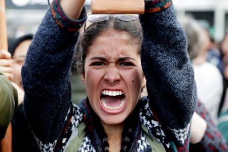 A demonstrator shouts slogans during a protest outside the Brazilian embassy due to the wildfires in the Amazon rainforest, in Lima