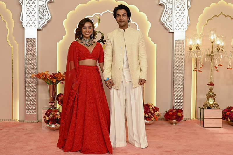 Bollywood actor Rajkummar Rao with his wife Patralekha (L) pose for photos as they arrive to attend the wedding ceremony of billionaire tycoon and Chairman of Reliance Industries Mukesh Ambani's son Anant Ambani and Radhika Merchant in Mumbai on July 12, 2024. Socialite sisters Kim and Khloe Kardashian were among the global celebrities spotted in India on July 12 to attend a lavish three-day wedding ceremony staged by Asia's richest man Mukesh Ambani. (Photo by SUJIT JAISWAL / AFP) (Photo by SUJIT JAISWAL/AFP via Getty Images)