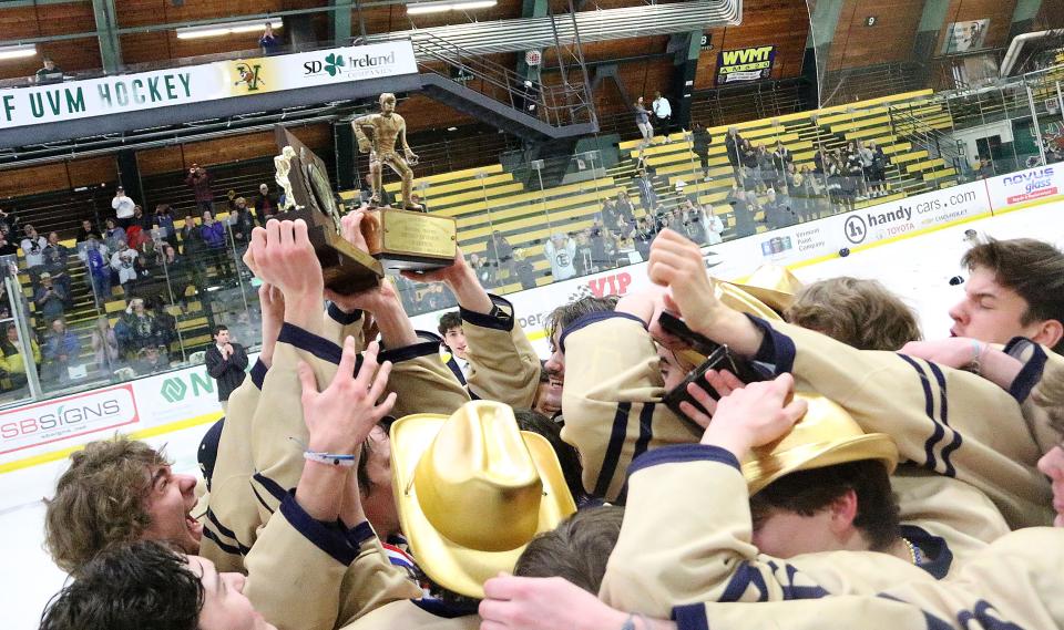 The Essex Hornets hoist the trophies after their 2-0 win over Rice in the D1 state title game on Wednesday night at UVM's Gutterson Fieldhouse.