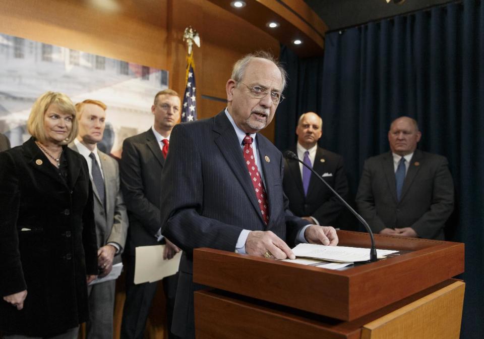 Rep. Norman "Doc" Hastings, R-Wash., center, discusses a new report that proposes alterations to the 40-year-old Endangered Species Act, Tuesday, Feb. 4, 2014, during a news conference on Capitol in Washington. Hastings, along with Rep. Cynthia Lummis, R-Wyo., left, led the Endangered Species Act Congressional Working Group, a panel of House Republicans who want the law to be administered by the states to balance wildlife protection with economic development. (AP Photo/J. Scott Applewhite)