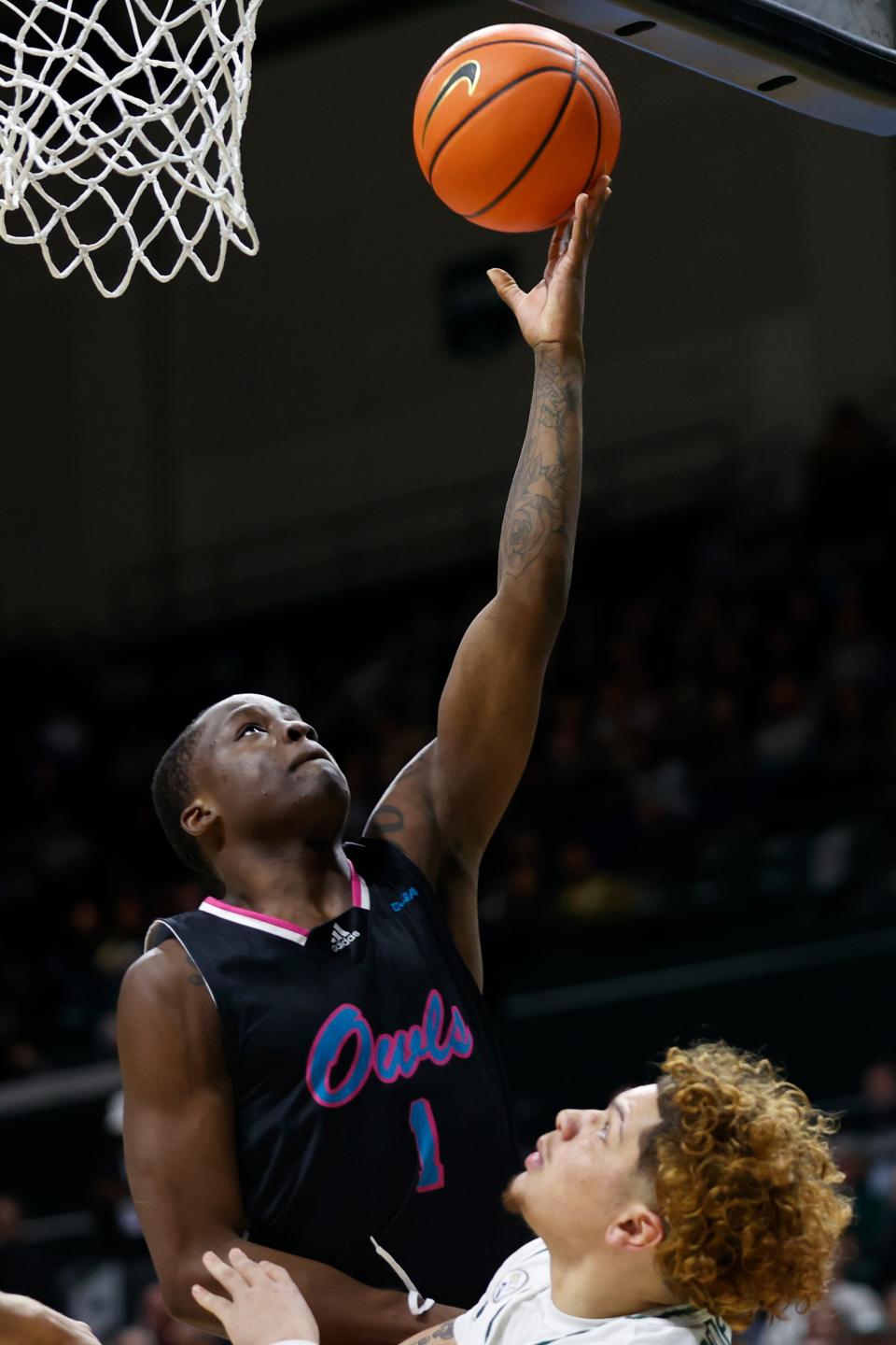 Florida Atlantic guard Johnell Davis, left, shoots over Charlotte guard Lu'Cye Patterson during the second half of an NCAA college basketball game in Charlotte, N.C., Saturday, Feb. 4, 2023. (AP Photo/Nell Redmond)