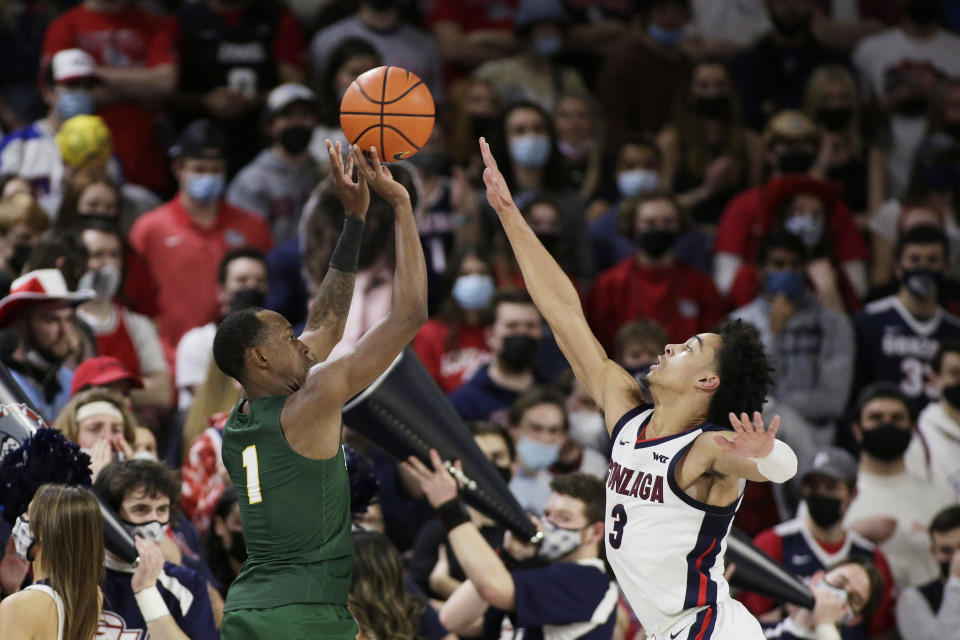 San Francisco guard Jamaree Bouyea (1) shoots over Gonzaga guard Andrew Nembhard (3) during the first half of an NCAA college basketball game Thursday, Jan. 20, 2022, in Spokane, Wash. (AP Photo/Young Kwak)