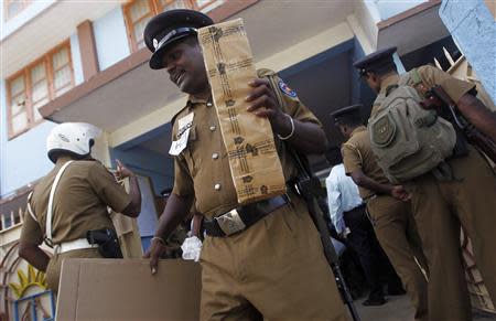 A police officer holds ballot papers as officers prepare to go to their polling centres ahead of first provincial polls in 25 years in Jaffna, a former war zone in northern Sri Lanka, about 400 kilometres (249 miles) north of Colombo September 20, 2013. REUTERS/Dinuka Liyanawatte