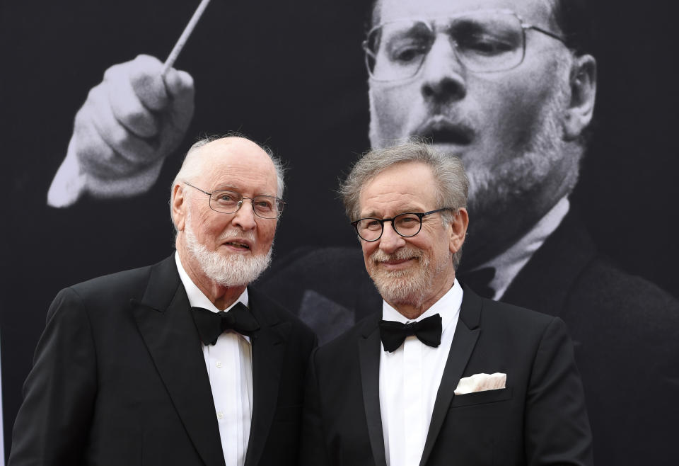 FILE - Composer John Williams, left, and director Steven Spielberg pose together at the 2016 AFI Life Achievement Award Gala Tribute to John Williams in Los Angeles on June 9, 2016. Williams, 90, is devoting himself to composing concert music, including a piano concerto he’s writing for Emanuel X. This spring, he and cellist Yo-Yo Ma released the album “A Gathering of Friends,” recorded with the New York Philharmonic. (Photo by Chris Pizzello/Invision/AP, File)