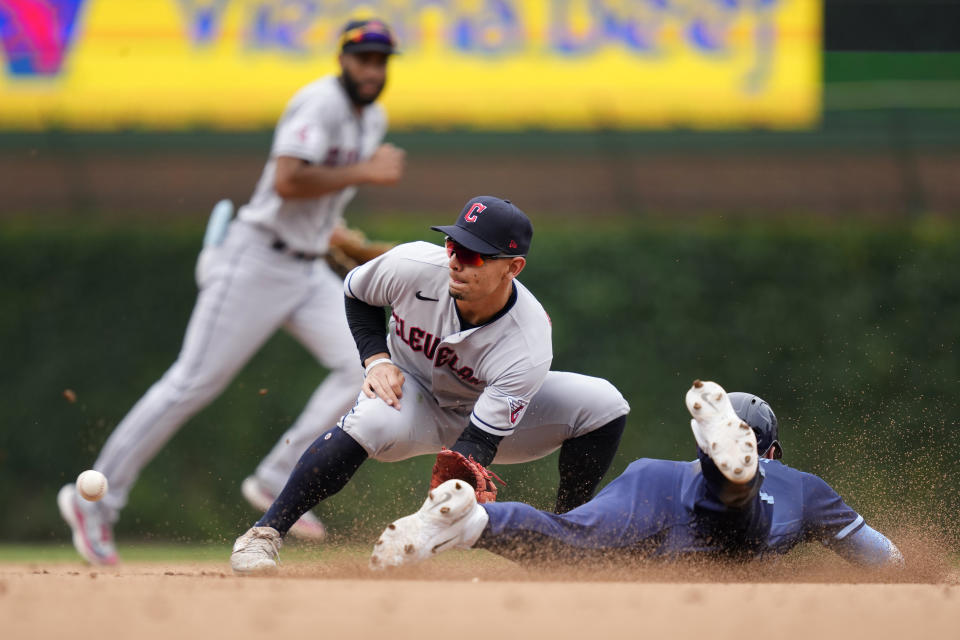 Chicago Cubs' Nico Hoerner steals second as Cleveland Guardians second baseman Andres Gimenez takes the throw from catcher Bo Naylor Friday, June 30, 2023, in Chicago. (AP Photo/Charles Rex Arbogast)