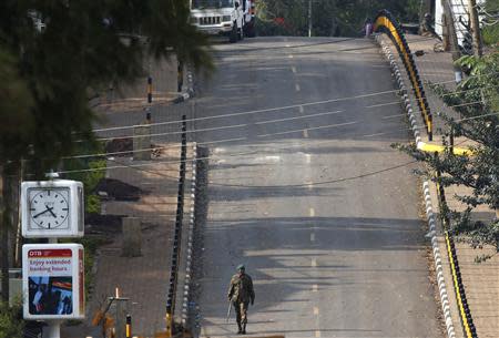 A Kenyan soldier walks outside the Westgate shopping centre in Nairobi September 23, 2013. REUTERS/Goran Tomasevic