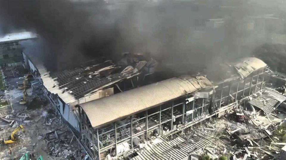 In this image made from video footage run by EBC, smoke billows from a factory of golf ball manufacturer Launch Technologies Co. in the southern county of Pingtung in Taiwan on Friday, Sept. 22, 2023. The golf ball factory fire has left multiple people killed, and the victims include several firefighters, according to Taiwanese media reports. (EBC via AP)