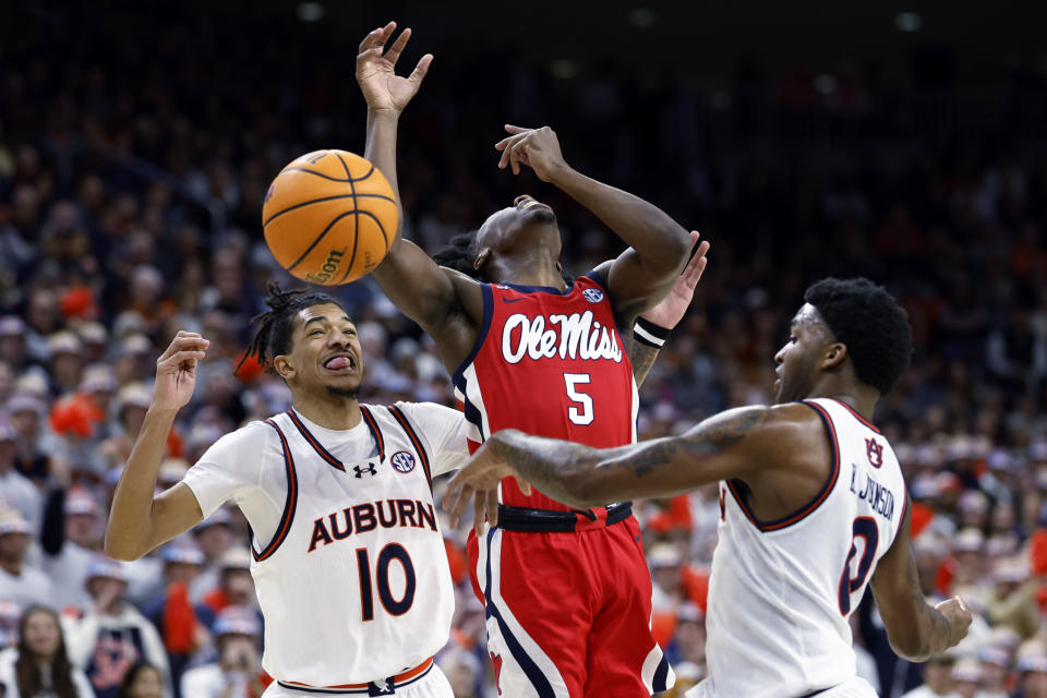 Auburn guard K.D. Johnson (0) strips the ball from Mississippi guard Jaylen Murray (5), as Auburn guard Chad Baker-Mazara (10) helps defen during the first half of an NCAA college basketball game Saturday, Jan. 20, 2024, in Auburn, Ala. (AP Photo/Butch Dill)