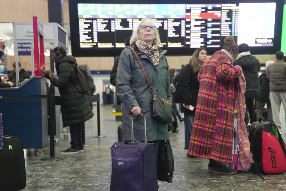 Passengers wait at the Euston Station in London, Monday, Jan. 22, 2024. Tens of thousands of people were without electricity and hundreds of trains were canceled on Monday after the latest in a wave of winter storms lashed Britain and Ireland with heavy rain and wind gusts of almost 100 miles (160 kilometers) an hour. (AP Photo/Kin Cheung)