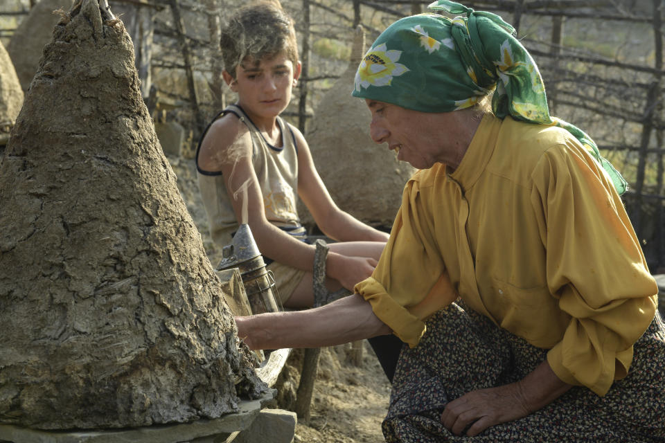 This image released by Neon shows Hatidze Muratova in a scene from "Honeyland," nominated for an Oscar for best documentary and best international feature film. (Neon via AP)