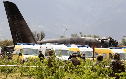 Algerian soldiers at the scene in Boufarik, near the Algerian capital, Algiers  - Credit:  AP