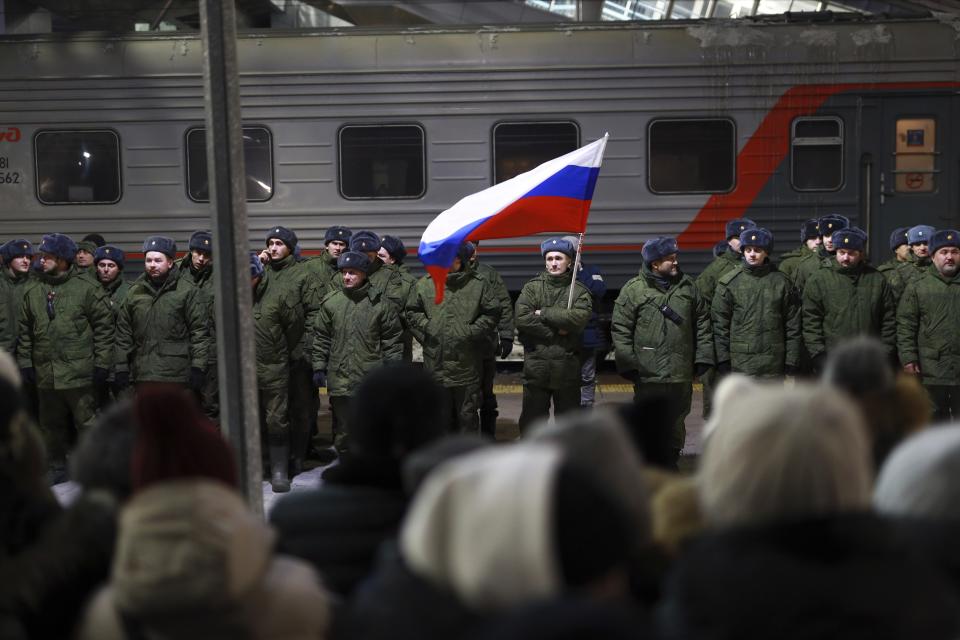 FILE - Soldiers who were recently mobilized by Russia for the military operation in Ukraine stand at a ceremony before boarding a train at a railway station in Tyumen, Russia, Friday, Dec. 2, 2022. Russian President Vladimir Putin's order to mobilize reservists for the conflict prompted large numbers of Russians to leave the country. (AP Photo, File)