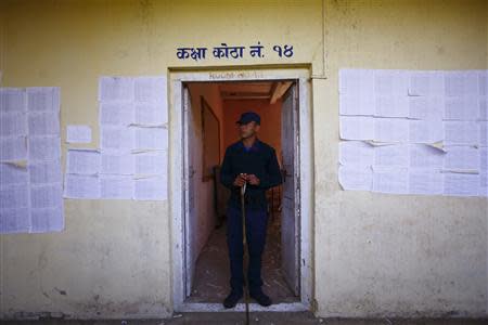 A police personnel recruited for the Constituent Assembly election, stands guard at a polling station a day before the election in Bhaktapur November 18, 2013. REUTERS/Navesh Chitrakar