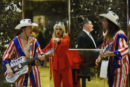 Kellyanne Conway, campaign manager and senior advisor to the Trump Presidential Transition Team, converses with "Naked Cowboy" themed street performers in the lobby at Trump Tower in New York, U.S., November 28, 2016. REUTERS/Lucas Jackson