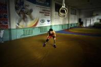 Mongolia's Olympic freestyle 60kg wrestler Mandakhnaran Ganzorig limbers up at a wrestling gym in Ulan Bator, October 27, 2011.