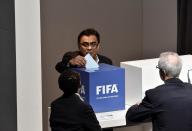 An official casts his ballot in the vote to decide on the next FIFA president