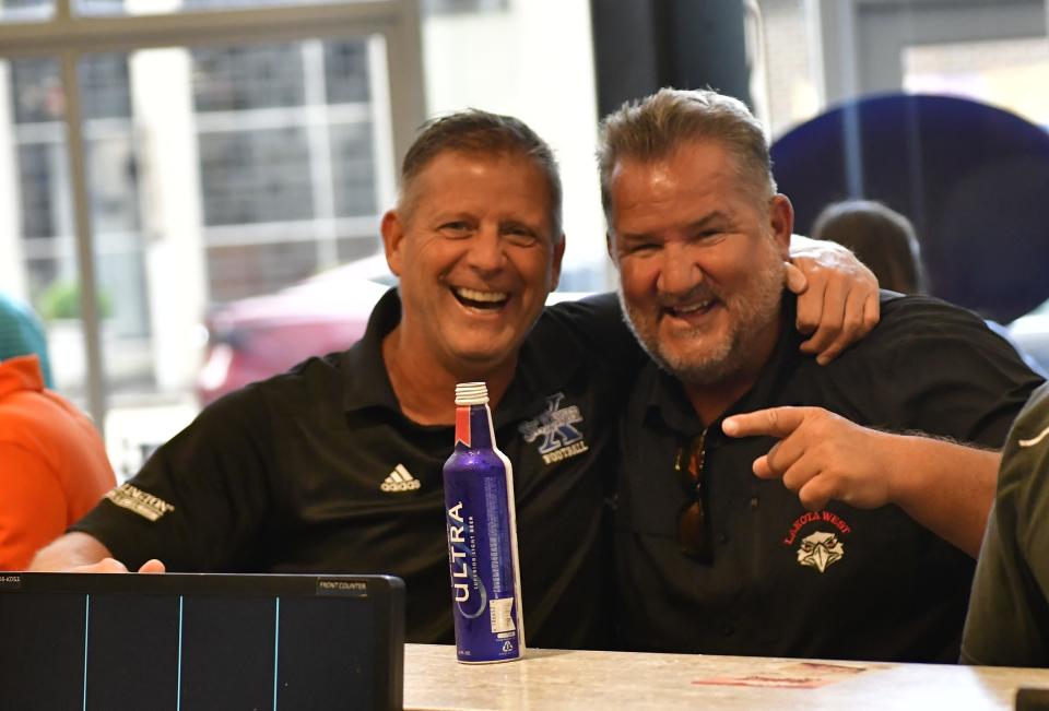 St. Xavier's Steve Specht and Lakota West's Tom Bolden enjoy the camaraderie at the 25th Anniversary Skyline Chili Crosstown Showdown football kickoff event, Aug. 3, 2022.