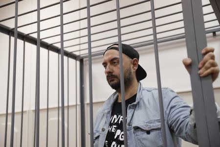 Russian theatre director Kirill Serebrennikov, who was detained and accused of embezzling state funds, stands inside the defendants' cage as he attends a hearing on his detention at a court in Moscow, Russia August 23, 2017. REUTERS/Tatyana Makeyeva