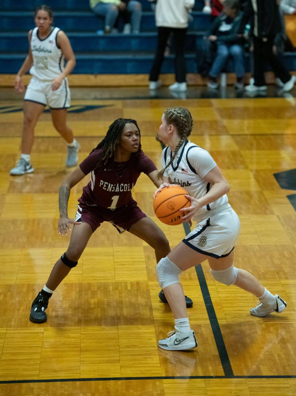 Pensacola High School's Ter'koiyah Long (No. 1) defends against 
Gulf Breeze High School's Lila Jacobs (No.23) during the Dolphin's home game against the visiting Tigers on Friday, Jan. 5, 2024.