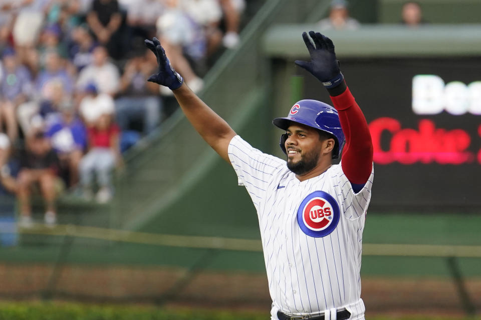 FILE - Chicago Cubs' Jeimer Candelario celebrates his single off Cincinnati Reds starting pitcher Ben Lively, after joining the Cubs in a trade with the Washington Nationals, during the first inning of a baseball game Tuesday, Aug. 1, 2023, in Chicago. Candelario has agreed to a $45 million, three-year contract with Cincinnati, giving the Reds a surplus of infielders that could lead to another move. A person familiar with the negotiations confirmed the agreement to The Associated Press on Thursday morning on condition of anonymity because it was pending a physical. The contract includes a club option that could take the value to $60 million over four years. (AP Photo/Charles Rex Arbogast, File)