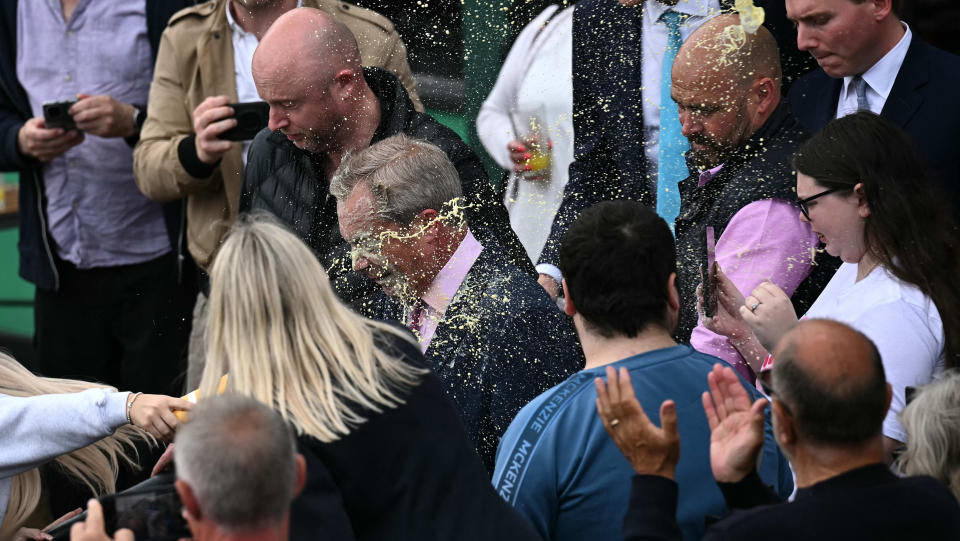 Newly appointed leader of Britain's right-wing populist party, Reform UK, and the party's parliamentary candidate for Clacton, Nigel Farage reacts as he is hit in the face by the contents of a drinks cup, during his general election campaign launch in Clacton-on-Sea, eastern England, on June 4, 2024.