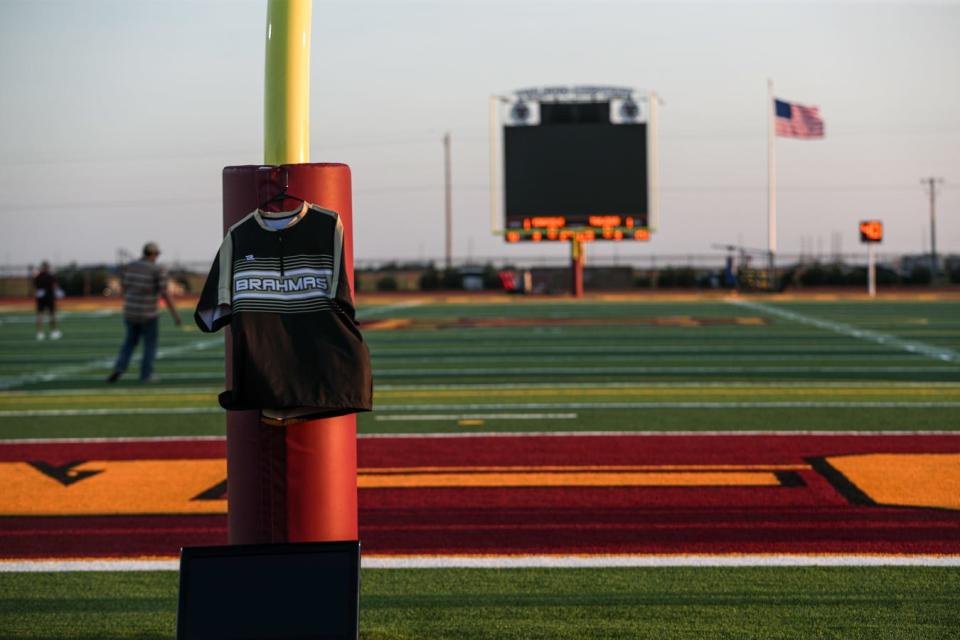 A Kingsville coach's shirt hangs on a field goal at Warrior Stadium while the staff prepares to leave after Friday's game is postponed, Sept. 22, 2023, in Corpus Christi, Texas.