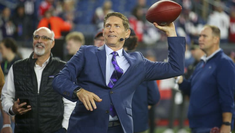 Former NFL quarterback and football analyst Steve Young throws a ball to a fan prior to an NFL football game between the Chicago Bears and New England Patriots, Monday, Oct. 24, 2022, in Foxborough, Mass. Young was reportedly among a group of ESPN broadcasters laid off by the network Friday.