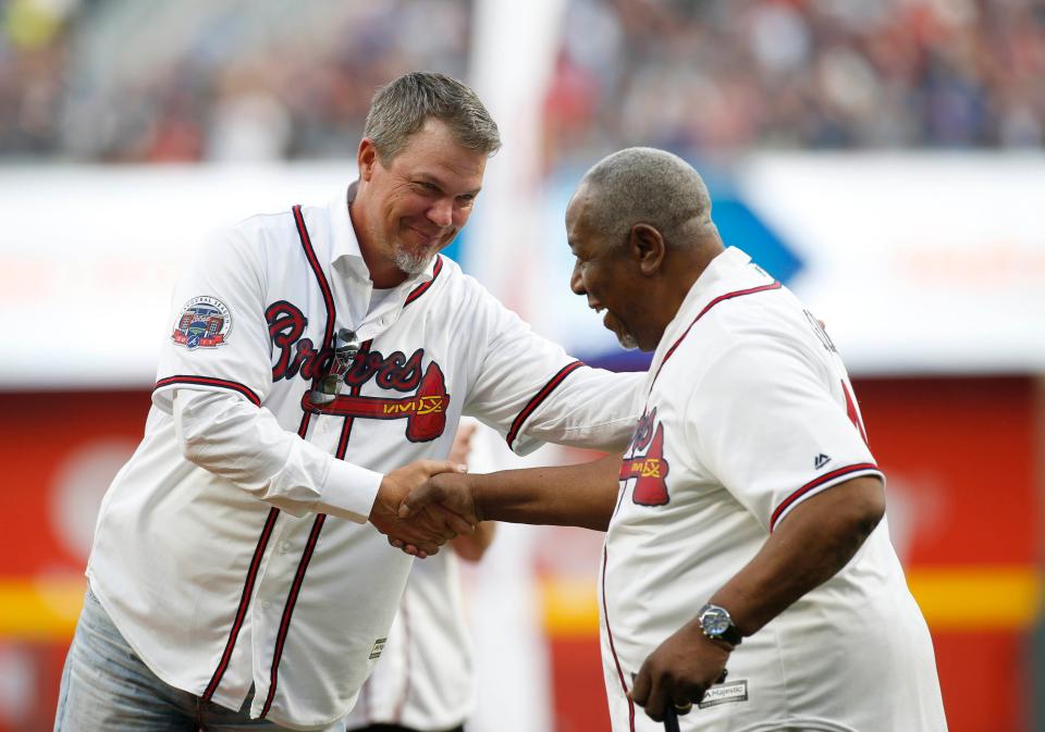 Atlanta Braves former third baseman Chipper Jones (left) shakes hands with Hall of Fame outfielder Hank Aaron prior to the first MLB game at SunTrust Park in Atlanta on April 14, 2017. Aaron died on Jan. 21, 2021, at the age of 86. Jones, who played baseball at The Bolles School of Jacksonville, would later be inducted into the Hall of Fame himself in 2018.