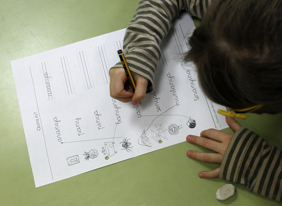 A pupil does handwriting exercises during a language class at a public school in El Masnou, near Barcelona, December 14, 2012.   Spain's leader vowed on Friday to press on with an education reform that has fueled separatist sentiment in Catalonia, where politicians were closing on a pact that could lead to a vote on independence. REUTERS/Albert Gea (SPAIN - Tags: POLITICS EDUCATION)