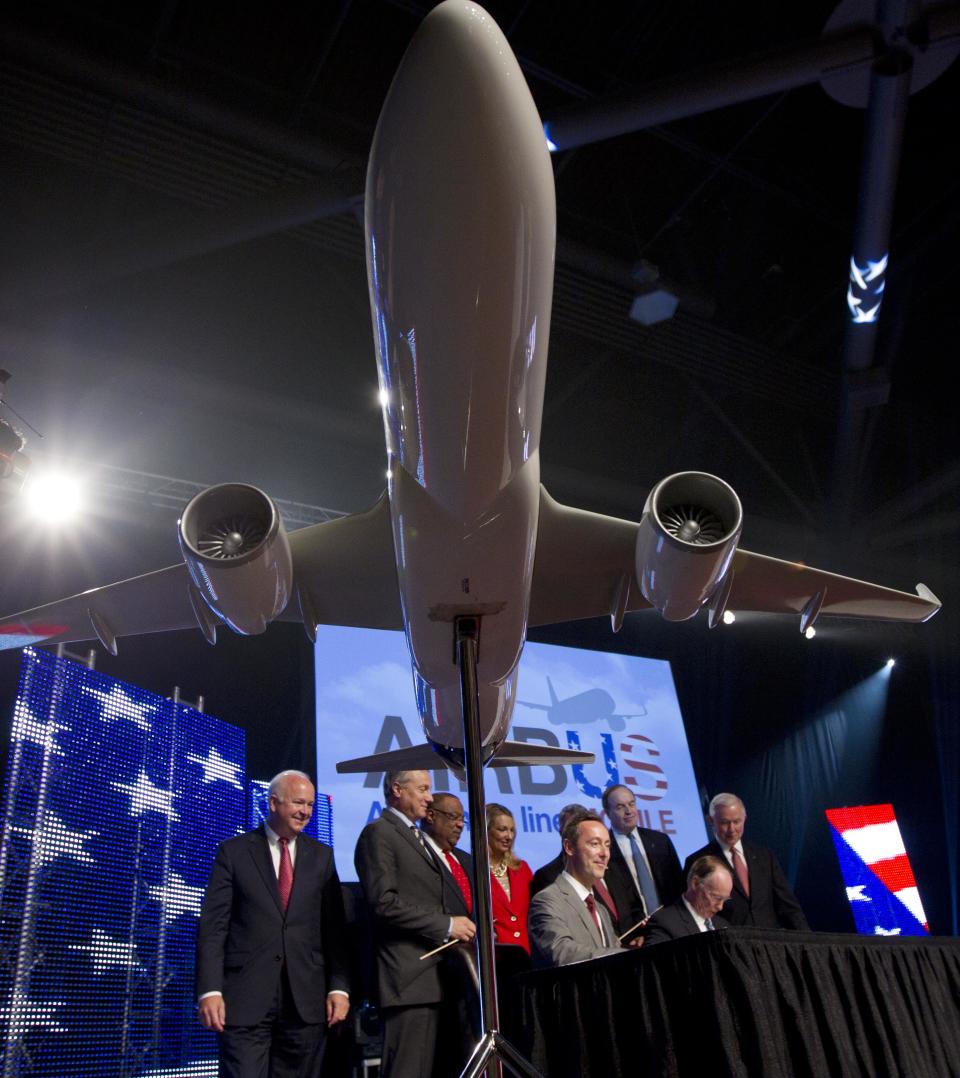 Alabama Gov. Robert Bentley, seated at right, and Airbus President & CEO Fabrice Bregier sign an agreement announcing that Airbus will establish its first assembly plant in the United States in Mobile, Ala., Monday, July 2, 2012. The French-based company said the Alabama plant is expected to cost $600 million to build and will employ 1,000 people when it reaches full production, likely to be four planes a month by 2017. (AP Photo/Dave Martin)