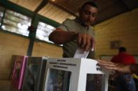 A man casts his vote during the presidential election at a polling station in Catacamas November 24, 2013. REUTERS/Tomas Bravo