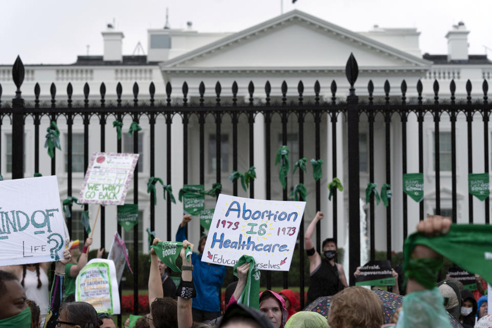 FILE - Abortion-rights demonstrators shout slogans after tying green flags to a fence at the White House during a protest to pressure the Biden administration to act and protect abortion rights, in Washington, July 9, 2022. Democrats are leaning into messaging strategy from pro-abortion rights groups, who have long advised candidates and elected officials to talk about reproductive rights. (AP Photo/Jose Luis Magana, File)