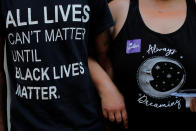 <p>Friends link arms at the site where Heather Heyer was killed during the 2017 Charlottesville “Unite the Right” protests in Charlottesville, Va., Aug. 10, 2018. (Photo: Brian Snyder/Reuters) </p>