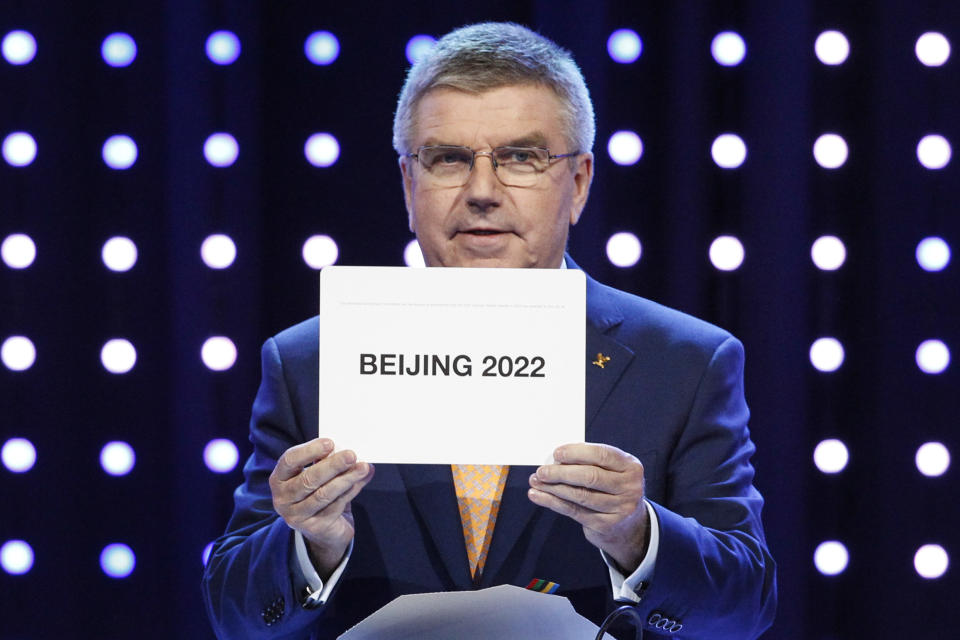 President of the International Olympic Committee (IOC) Thomas Bach opens the envelope announcing that Beijing has won the bid to host the 2022 Winter Olympic Games at the 128th International Olympic Committee session in Kuala Lumpur, Malaysia, Friday, July 31, 2015. Almaty and Beijing competed for the right to host the 2022 Winter Olympic Games. (AP Photo/Joshua Paul)