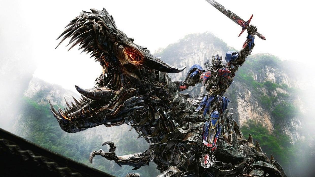 optimus prime rides a dinosaur in a scene from transformers age of extinction