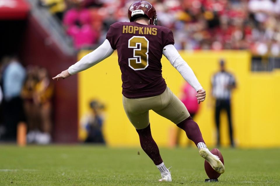 Dustin Hopkins kicks off as a member of the Washington Football Team.