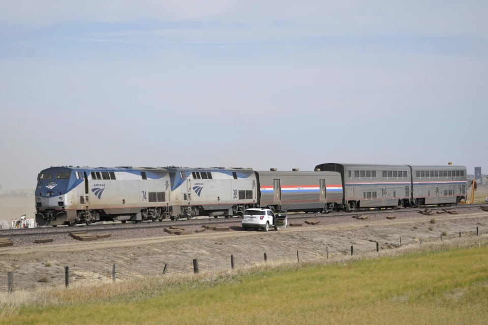 Engines and cars from an Amtrak train that derailed a day earlier are shown Sunday, Sept. 26, 2021, at the derailment site just west of Joplin, Mont.. The crash killed three people and injured others. The westbound Empire Builder was en route to Seattle from Chicago, with two locomotives and 10 cars. (AP Photo/Ted S. Warren)