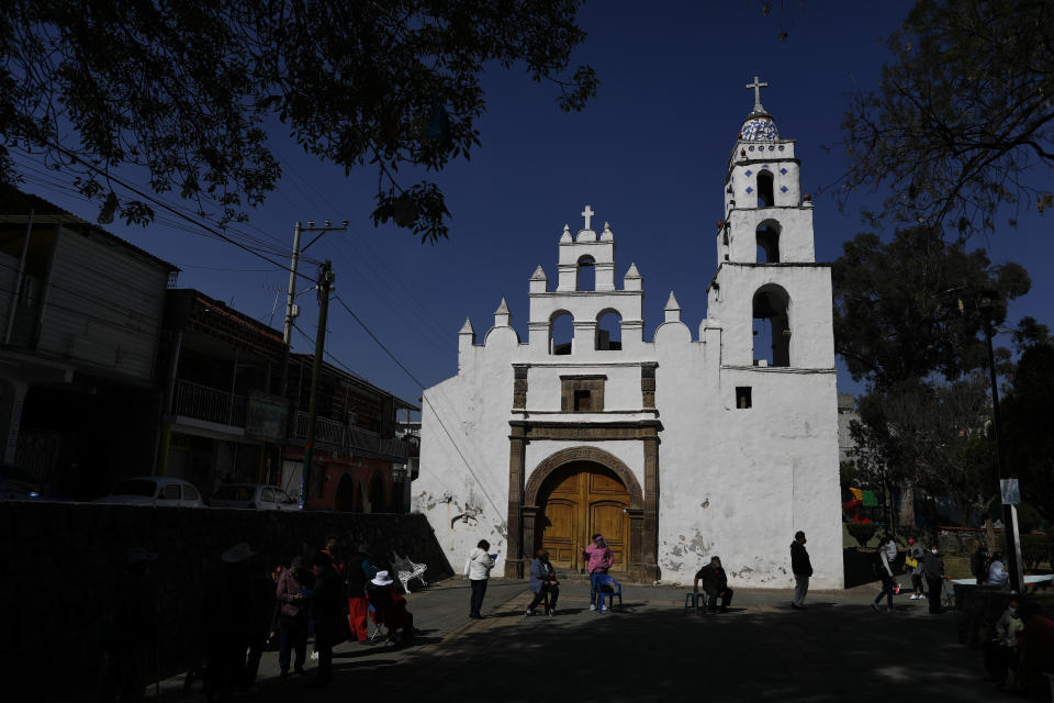 People over age 60 wait in an hours-long line to get the AstraZeneca vaccine, on the day Mexico begins vaccinating its elderly population against COVID-19, outside a health center in the outlying Milpa Alta borough of Mexico City, Monday, Feb. 15, 2021. (AP Photo/Rebecca Blackwell)