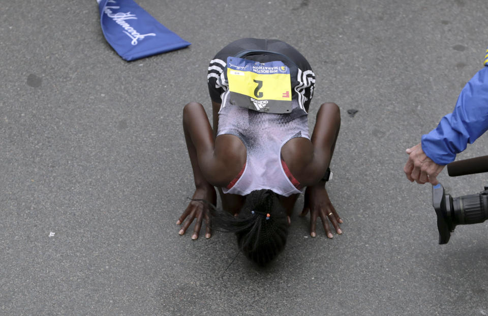 Worknesh Degefa, of Ethiopia, kisses the ground after winning the women's division of the 123rd Boston Marathon on Monday, April 15, 2019, in Boston. (AP Photo/Charles Krupa)