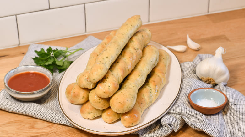 plate of breadsticks with herbs 